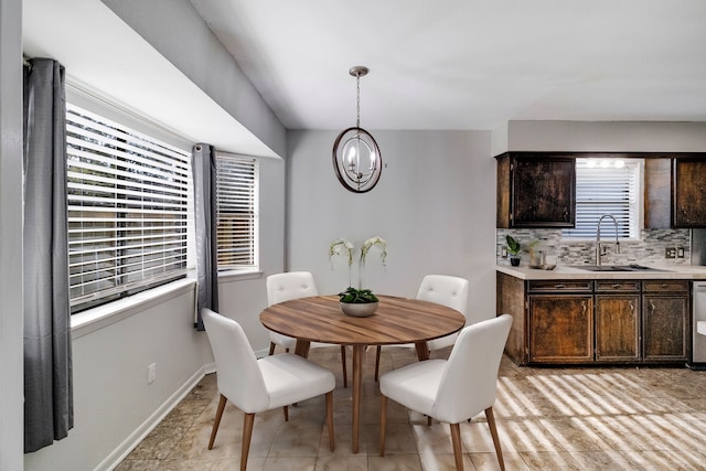 dining room with sink and a chandelier