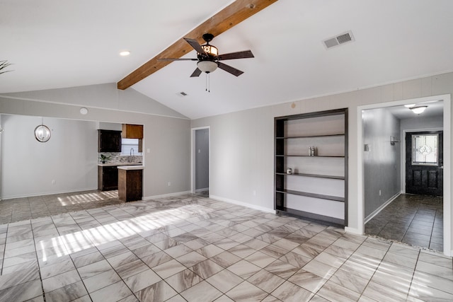 unfurnished living room featuring lofted ceiling with beams, ceiling fan, and built in shelves