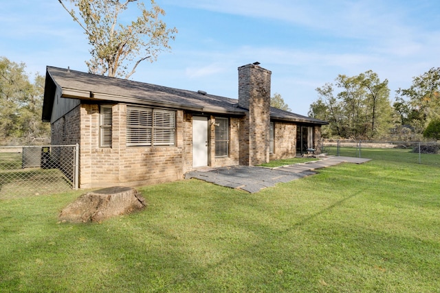 rear view of property with a patio area and a lawn