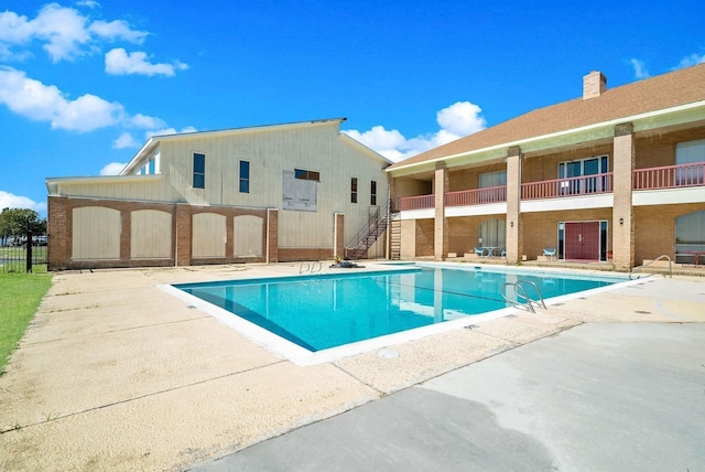 view of swimming pool with a patio