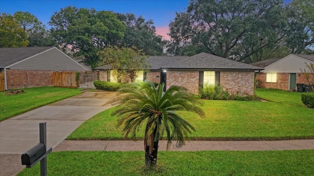 ranch-style house with a yard