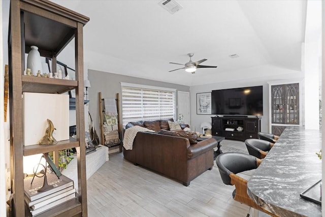 living room with ceiling fan and light hardwood / wood-style floors