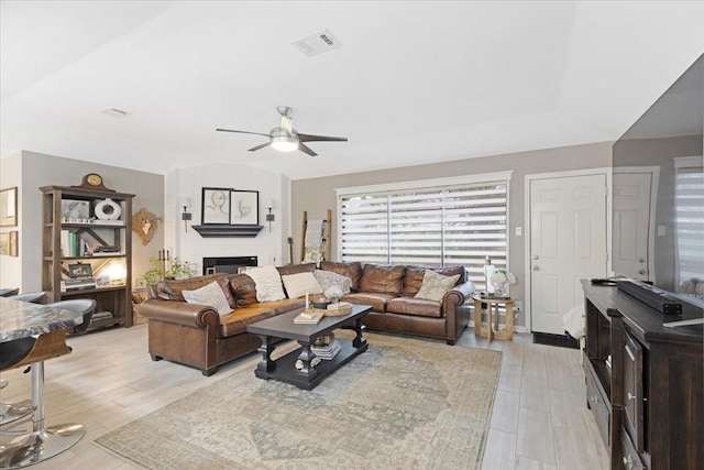 living room featuring light wood-type flooring and ceiling fan