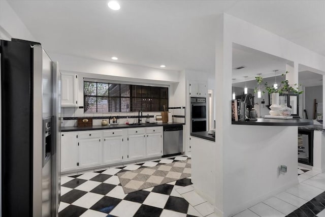 kitchen with backsplash, sink, white cabinets, and stainless steel appliances