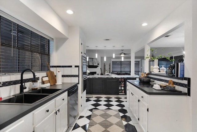 kitchen featuring dishwasher, ceiling fan, white cabinetry, and sink