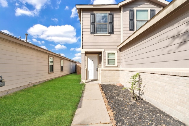 doorway to property featuring a yard