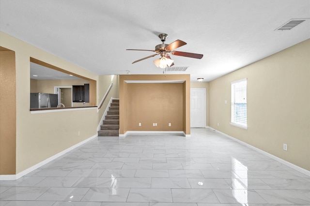 unfurnished living room featuring ceiling fan