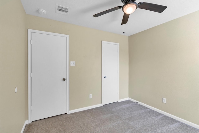 unfurnished bedroom featuring carpet and ceiling fan