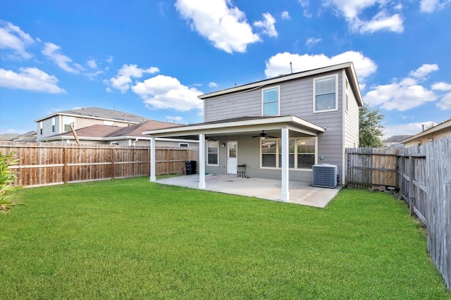 rear view of house with a lawn, central AC, ceiling fan, and a patio