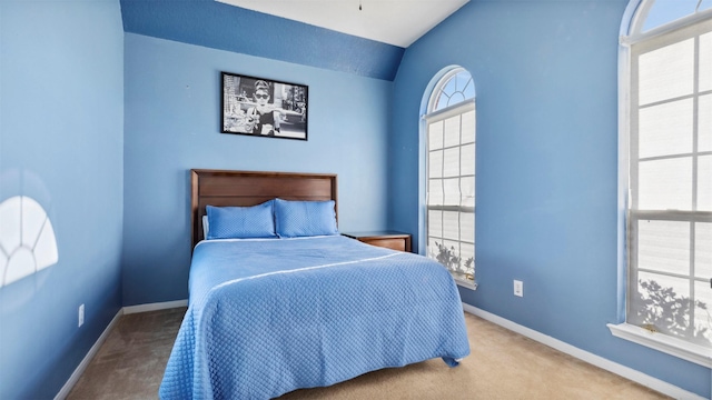 carpeted bedroom featuring lofted ceiling