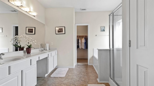 bathroom with tile patterned flooring, vanity, and an enclosed shower