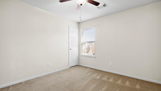 unfurnished room featuring light carpet and ceiling fan