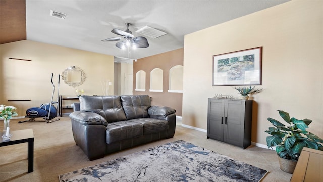 carpeted living room featuring ceiling fan and vaulted ceiling