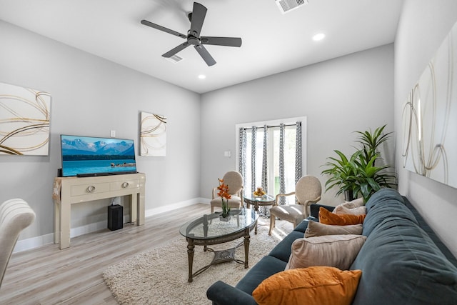 living room featuring light hardwood / wood-style flooring and ceiling fan