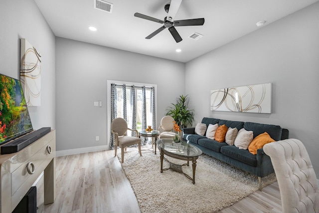 living room featuring ceiling fan and light hardwood / wood-style flooring