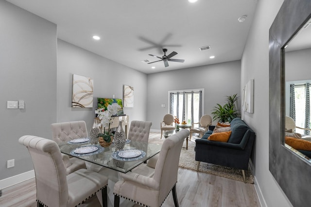 dining area with light hardwood / wood-style flooring, ceiling fan, and a healthy amount of sunlight