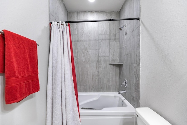 bathroom with toilet and shower / tub combo with curtain