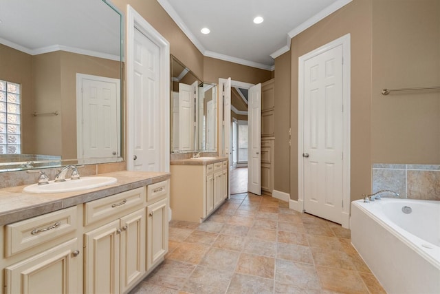 bathroom with vanity, a tub to relax in, and crown molding