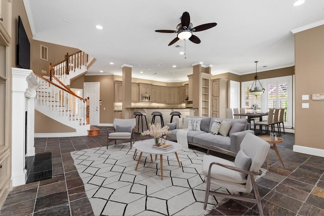 living room with ceiling fan and crown molding