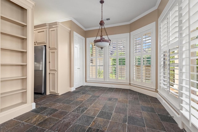 unfurnished dining area with plenty of natural light and ornamental molding