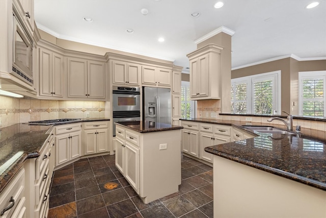 kitchen featuring appliances with stainless steel finishes, sink, and cream cabinets