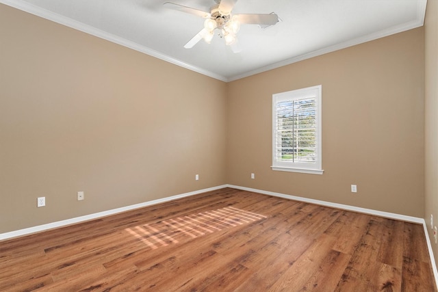 empty room featuring hardwood / wood-style flooring, ceiling fan, and ornamental molding