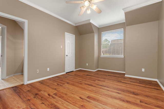 empty room with light wood-type flooring, ceiling fan, and crown molding