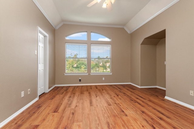 empty room with lofted ceiling, light hardwood / wood-style flooring, ceiling fan, and crown molding