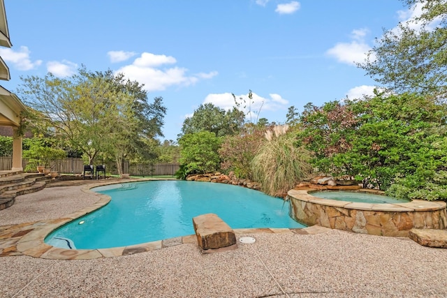 view of pool with an in ground hot tub and a patio