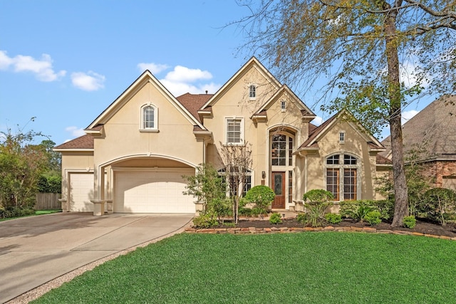 view of front facade with a garage and a front lawn