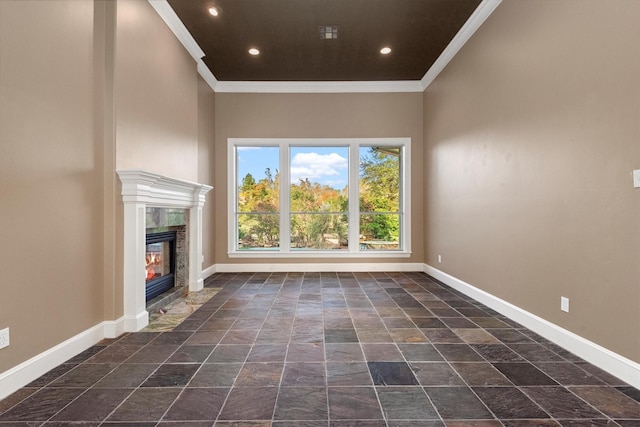 unfurnished living room with ornamental molding and a premium fireplace