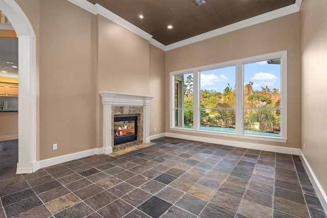 unfurnished living room featuring a high end fireplace and ornamental molding