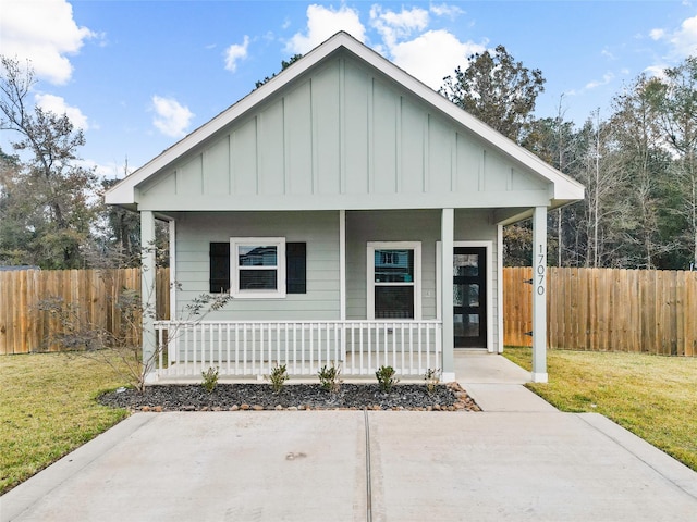 bungalow-style home with a porch and a front yard