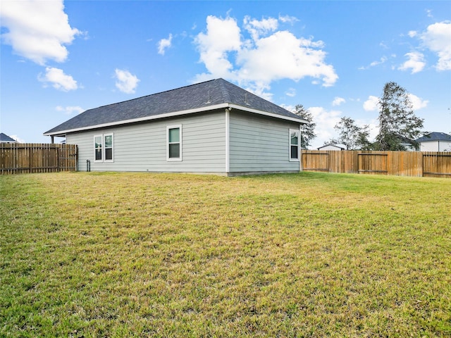 back of house featuring a yard