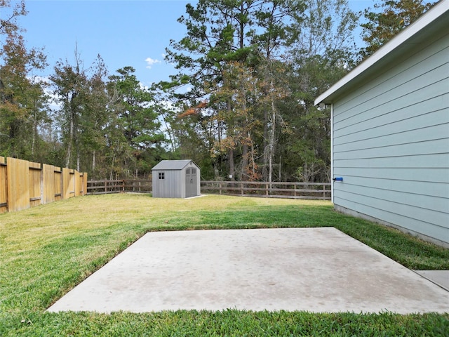 view of yard with a storage shed and a patio