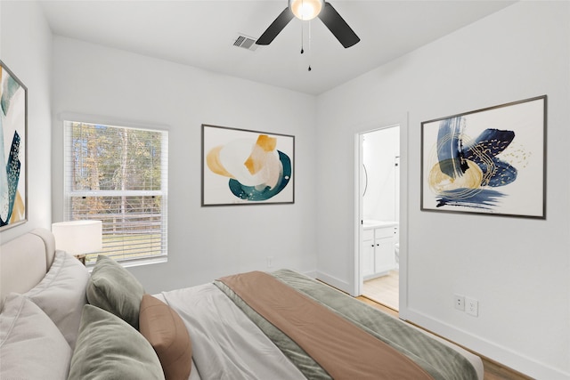 bedroom with ensuite bathroom, wood-type flooring, and ceiling fan