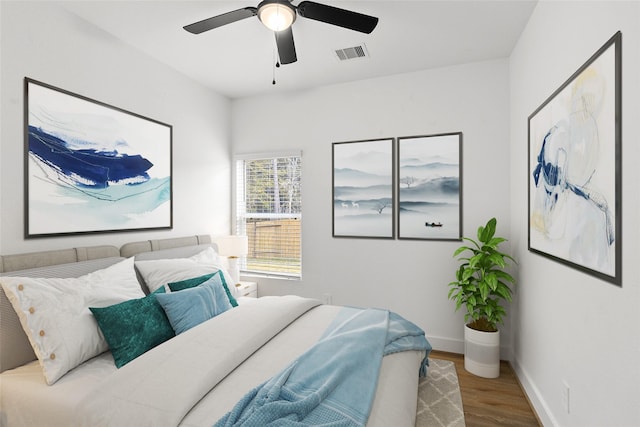 bedroom with ceiling fan and light hardwood / wood-style flooring