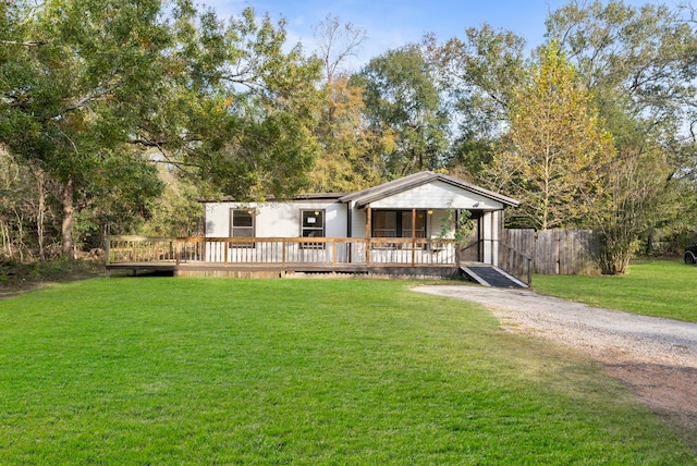 view of front of property featuring a wooden deck and a front yard