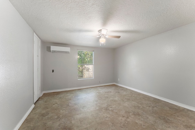 unfurnished room with ceiling fan, a textured ceiling, and a wall unit AC