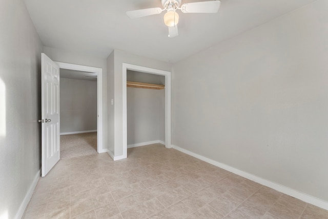 unfurnished bedroom with ceiling fan and a closet