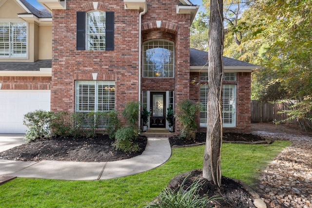 view of front of home featuring a garage and a front lawn