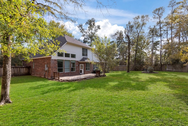 rear view of house with a yard and a patio