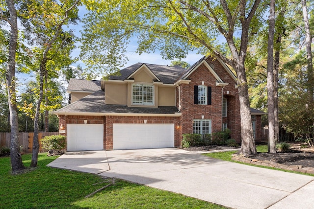 front of property with a front yard and a garage