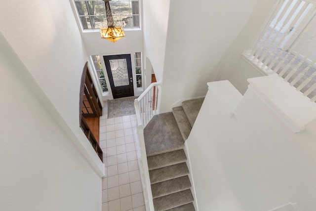 tiled entrance foyer featuring a chandelier