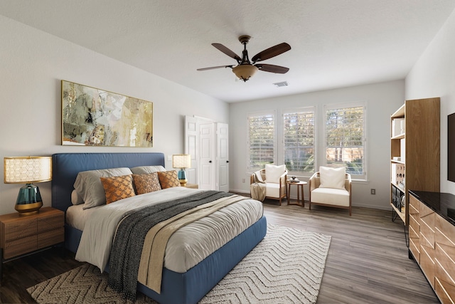 bedroom with ceiling fan and dark hardwood / wood-style floors