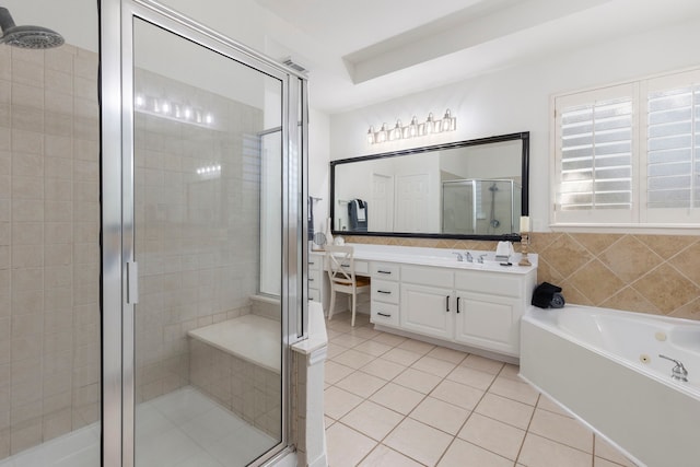 bathroom featuring tile patterned flooring, vanity, tile walls, and plus walk in shower