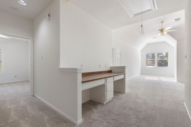 corridor featuring light carpet and vaulted ceiling