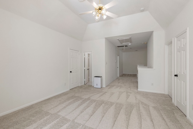 empty room with ceiling fan, light colored carpet, and lofted ceiling