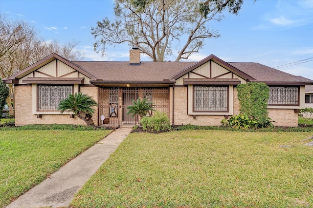 tudor home with a front yard