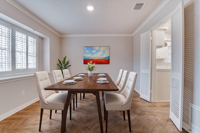 dining room featuring a textured ceiling, ornamental molding, and light parquet floors